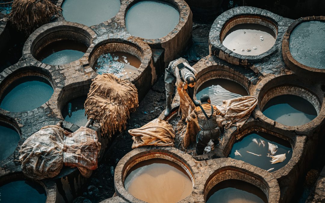 Men working at Chouwara Leather traditional tannery in ancient medina of Fes El Bali, Morocco, Africa
